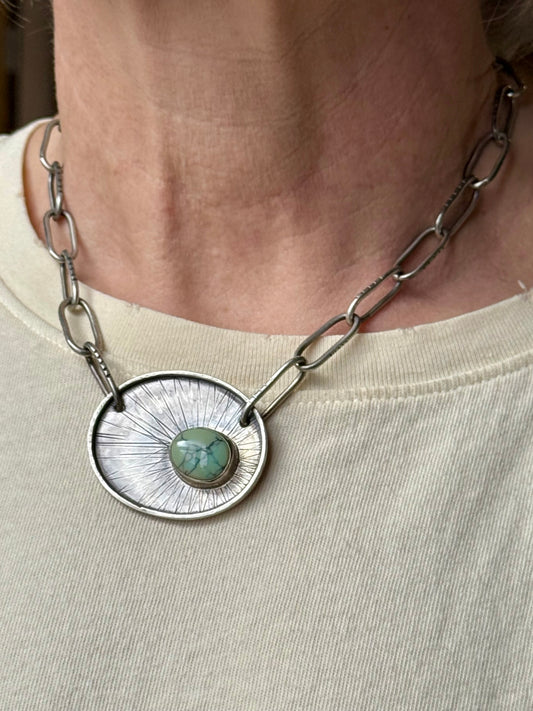 Handmade variscite pendant necklace in hand-textured sterling silver, one-of-a-kind artisan jewelry shown on a neck